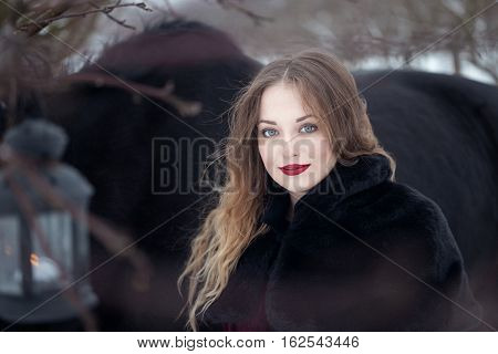 Girl In Dark Clothes With A Black Horse