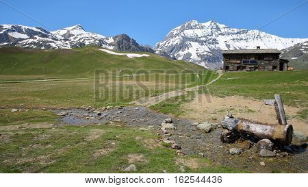 VANOISE, FRANCE - JUNE 23, 2016: Plan-du-Lac refuge with Two summits (Rechasse and Grande Casse) in the background, Northern Alps