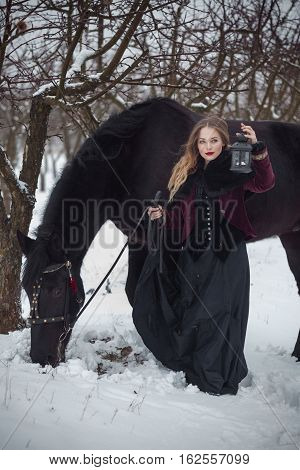 Girl In Dark Clothes With A Black Horse