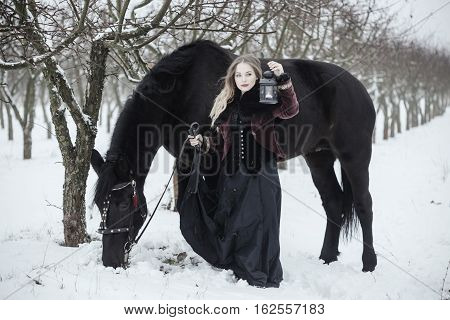Girl In Dark Clothes With A Black Horse