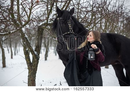 Girl In Dark Clothes With A Black Horse