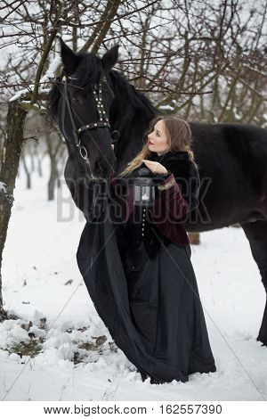 Girl In Dark Clothes With A Black Horse