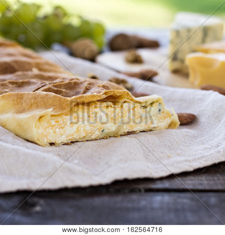 Сheese pie strudel with cheese cheese pie 4. Wine grapes nuts cheese blue cheese and coffee. dinner lunch romantic date picnic eating on nature.