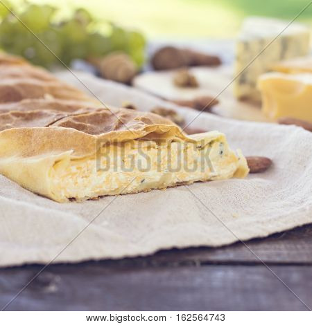 Сheese pie strudel with cheese cheese pie 4. Wine grapes nuts cheese blue cheese and coffee. dinner lunch romantic date picnic eating on nature.