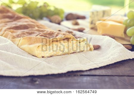 Сheese pie strudel with cheese cheese pie 4. Wine grapes nuts cheese blue cheese and coffee. dinner lunch romantic date picnic eating on nature.