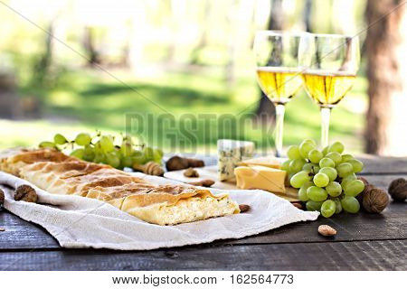 Сheese pie strudel with cheese cheese pie 4. Wine grapes nuts cheese blue cheese and coffee. dinner lunch romantic date picnic eating on nature.