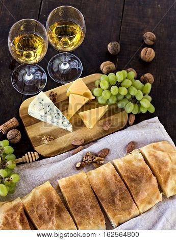 Сheese pie strudel with cheese cheese pie 4. Wine grapes nuts cheese blue cheese and coffee. dinner lunch romantic date picnic eating on nature.