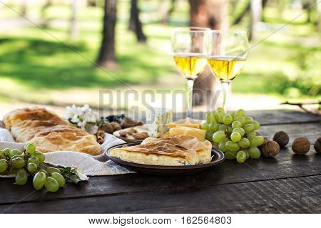 Сheese pie strudel with cheese cheese pie 4. Wine grapes nuts cheese blue cheese and coffee. dinner lunch romantic date picnic eating on nature.