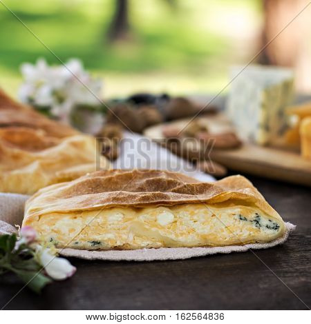 Сheese pie strudel with cheese cheese pie 4. Wine grapes nuts cheese blue cheese and coffee. dinner lunch romantic date picnic eating on nature.