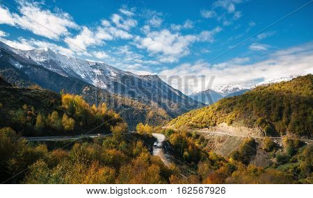 Scenic winding serpentine road in Caucasus mountains from Zugdidi to Mestia resort in gold autumn against sky Samegrelo-Zemo Upper Svaneti Georgia. Georgian landscape
