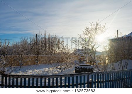 Photo by evening sun in the winter courtyard of rustic house.