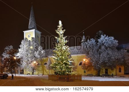 Beautiful Night Winter Photo Christmas Tree With Church And Snow.