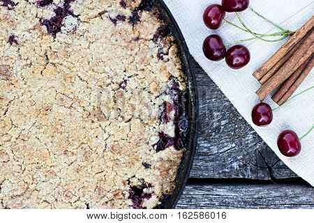 Homemade Cherry crumble and cherries on an old wooden table background.Selective focus.