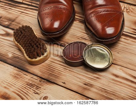 Shoe care. Shoe wax and brushes on wooden surface. Glacage shoes. Oxfords.waxing.Bull shoes.Finger polish.