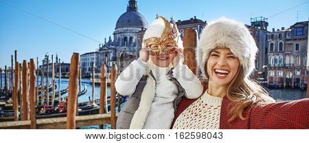 Smiling Mother And Child Travellers Taking Selfie In Venice