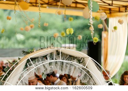 A wedding altar decorated with green bows and straw balls