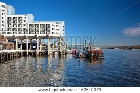 Hotel on the riverside , promenade, restaurant and cruise  paddle wheeler.