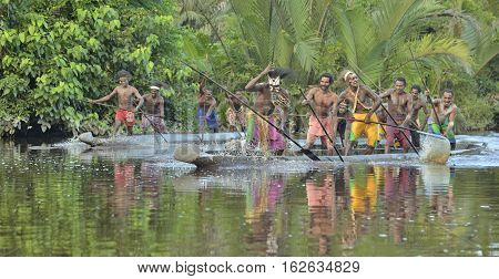INDONESIA IRIAN JAYA ASMAT PROVINCE JOW VILLAGE - JUNE 23: Canoe war ceremony of Asmat people. Headhunters of a tribe of Asmat . New Guinea Island Indonesia. June 23 2016