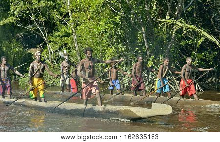 INDONESIA IRIAN JAYA ASMAT PROVINCE JOW VILLAGE - JUNE 23: Canoe war ceremony of Asmat people. Headhunters of a tribe of Asmat . New Guinea Island Indonesia. June 23 2016