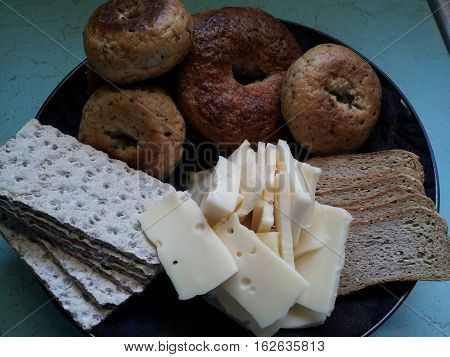 Breads, grains, and cheese on a plate.