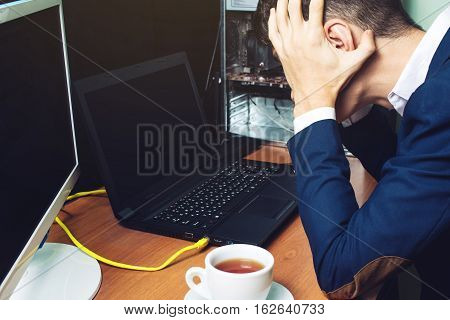 Man Holding His Head Looking At The Monitor Broken Computer