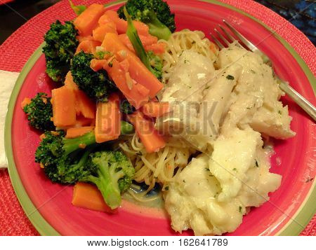 Fish and vegetable dinner on a plate
