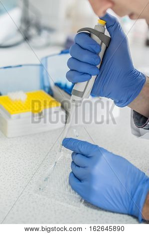 Scientific Laboratory Technician Pipetting. Macro Shot