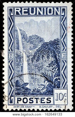 LUGA RUSSIA - NOVEMBER 06 2016: A stamp printed by REUNION shows beautiful view of the Salazie Waterfall. Reunion is an island and region of France in the Indian Ocean circa 1933.