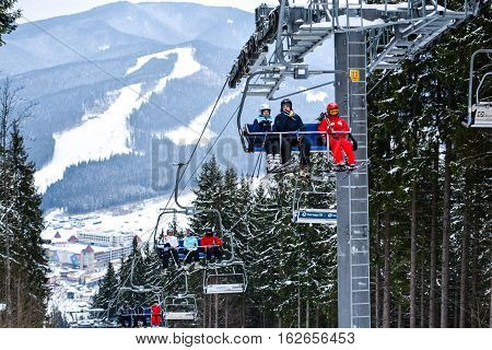BUKOVEL, UKRAINE - December 17, 2016 : Skiers on a cable car in Bukovel. Bukovel is the most popular ski resort in Ukraine. Ski season and Winter sports concept