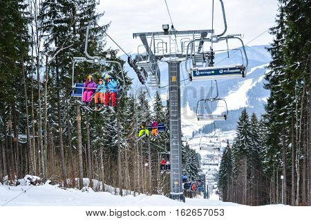 BUKOVEL, UKRAINE - December 17, 2016 : Skiers on a cable car in Bukovel. Bukovel is the most popular ski resort in Ukraine. Ski season and Winter sports concept