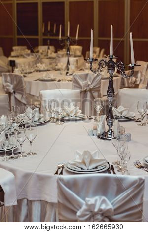 Empty plate glasses and silverware set on white table