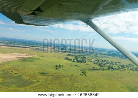 Aerial view of fields from plane at summer day