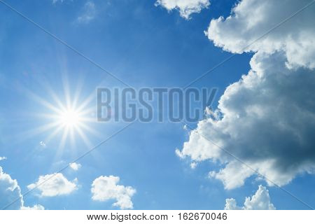 Sun flare with cloudy blue sky background .