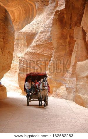 PETRA, JORDAN - MARCH 13, 2016: The Siq Canyon leading to The Treasury (Al Khazneh)