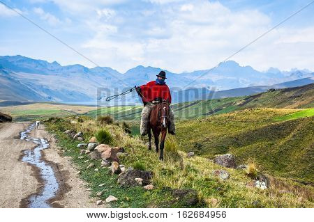 Ozogoche Ecuador December 19 2015: Unidentified Cowboys with red poncho and 