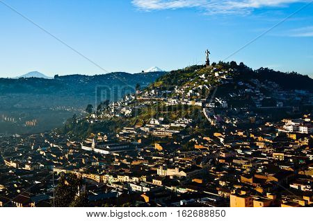 View of El Panecillo in the center of Quito with the Cotopaxi in the background