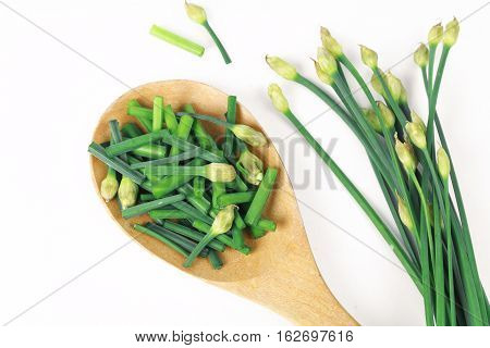 bunch of fresh chives on a wooden cutting board