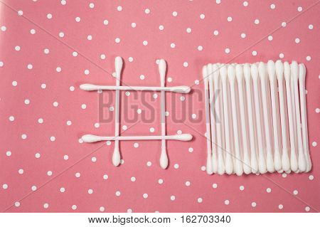 facials skin care. cotton pads and buds on the pink backgroung