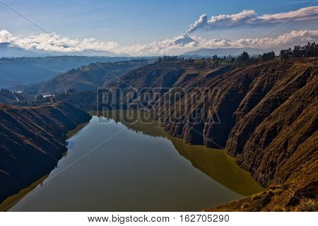 Lagoon of Yambo and Tungurahua volcano explosion on November 2010 at dawn Ecuador