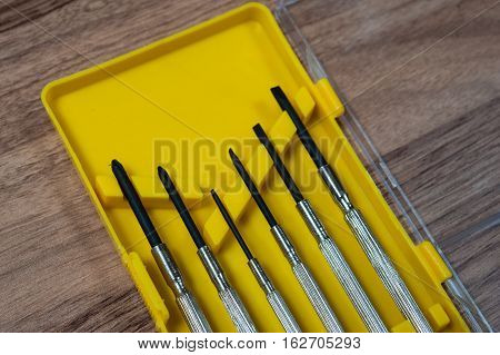 mini screwdriver set in a yellow box on the table