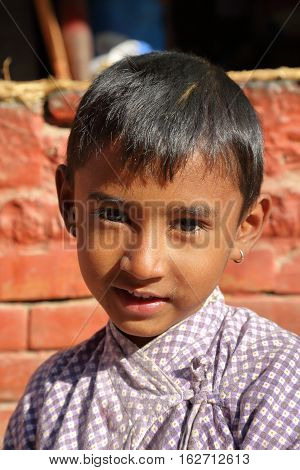 BODHNATH, NEPAL - DECEMBER 24, 2014: Portrait of a little girl at Ichangu Narayan Temple near Kathmandu