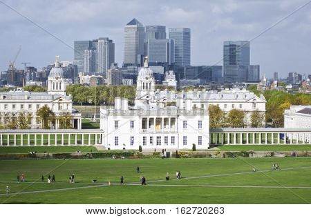 London UK - Oct 25 2009: The skyline of the Canary Wharf business district of London. The foreground features the Royal Naval College. Photo taken from the top of the hill at Greenwich park.