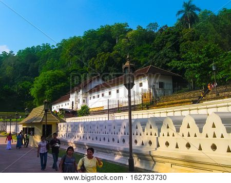Kandy, Sri Lanka - May 02, 2009: The people going to Temple Of The Sacred Tooth Relic, located in the Royal Palace Complex Of The Former Kingdom Of Kandy, Sri Lanka on May 02, 2009