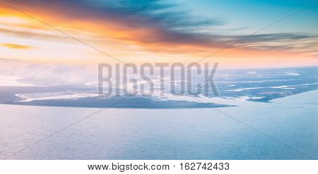 Western Dvina Flows Into The Baltic Sea. River Divides The Northern And Kurzeme District Of Riga Latvia. View From Airplane Flight. Sunset Sunrise Over Gulf Of Riga Bay Of Riga Or Gulf Of Livonia