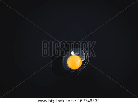 natural egg on black background and cholesterol