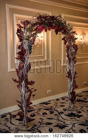 wedding arch, it is issued from dry plants, red, gray