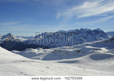 amazing scenic view of snow mountains and ski resort in Switzerland Europe on a cold sunny day with blue sky at Saint Moritz Corvatsch peak in Engadin in winter vacation and holiday concept