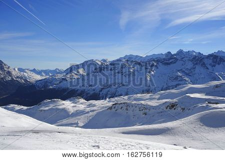 amazing scenic view of snow mountains and ski resort in Switzerland Europe on a cold sunny day with blue sky at Saint Moritz Corvatsch peak in Engadin in winter vacation and holiday concept