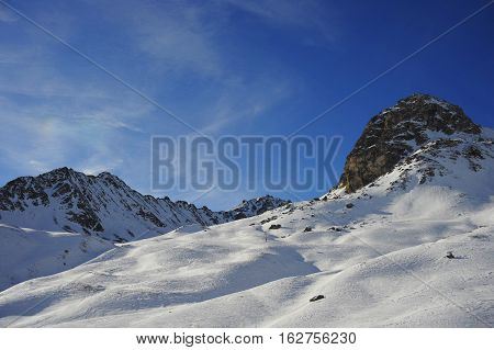 amazing scenic view of snow mountains and ski resort in Switzerland Europe on a cold sunny day with blue sky at Saint Moritz Corvatsch peak in Engadin in winter vacation and holiday concept