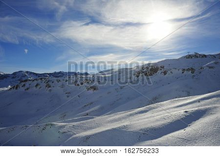 amazing scenic view of snow mountains and ski resort in Switzerland Europe on a cold sunny day with blue sky at Saint Moritz Corvatsch peak in Engadin in winter vacation and holiday concept